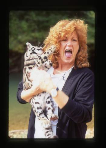JoGayle Howard smiles with a clouded leopard. 